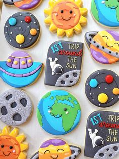 decorated cookies with the names of different planets and stars are displayed on a sheet of white paper