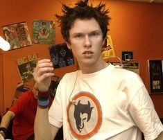 a young man holding up some cards in his hand