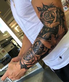 a man with a rose tattoo on his arm