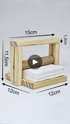 a small wooden box with white napkins in it and the measurements for each item