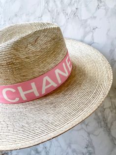 Handmade by artisans in Mexico, our new 100% baked palm leaf Islander Hat is perfect for spring and summer wear. Featuring a molded crown and tightly woven pressed palm, this hat offers the most sun protection. Embellished with a faux suede band and exclusive cut Swarovski crystals. - Hat is one size fits all and the band on the inside is stretchy. If you think you’ll want a tighter fit or have a smaller head, we can attach a foam piece behind the band to reduce the size. - Can be removed. REQUE White Straw Hat For Spring With Flat Crown, White Flat Crown Sun Hat For Spring, White Flat Crown Straw Hat For Kentucky Derby, White Flat Crown Hat Bands For Beach, White Sun Hat With Flat Crown For Vacation, White Straw Hat With Flat Crown For Vacation, White Flat Crown Panama Hat For Summer, White Beach Hat With Flat Crown, White Flat Crown Sun Hat For The Beach