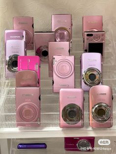 there are many pink cameras on the shelf