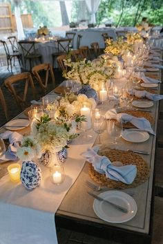 a long table is set with candles and plates