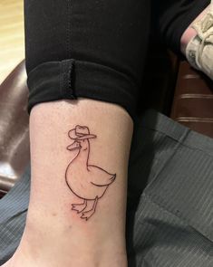 a small duck tattoo on the ankle