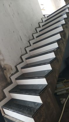 a set of stairs with black and white treads