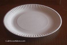 a white paper plate sitting on top of a wooden table