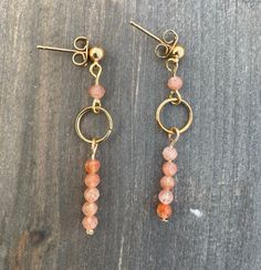 These earrings are handmade with 3mm faceted sunstone beads and 18k gold plated earring posts.  *Because this jewelry is made of natural gemstones, please allow for small variations in gemstone size, color, and texture. However, every effort will be made to have the product accurately match the image shown on the listing Shipping Information ---------------------- This jewelry is made to order. Please allow 1-3 business days for your item to be handcrafted.  If you have any questions please feel free to message me. Thank you for visiting my shop! 14k Gold Filled Beaded Earrings For Gift, 14k Gold Filled Beaded Earrings As Gift, Gold Dangle Earrings With Gemstone Beads, Natural Stone Jewelry, Earring Posts, Star Bracelet, Pretty Bracelets, Jewelry Gemstone, Gold Plated Earrings