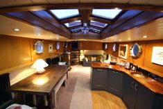 the inside of a boat with wood paneling and skylights on the ceiling is shown