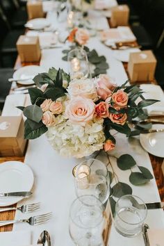 a long table is set with flowers and candles for a formal dinner or wedding reception