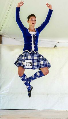 a man in a kilt jumping into the air