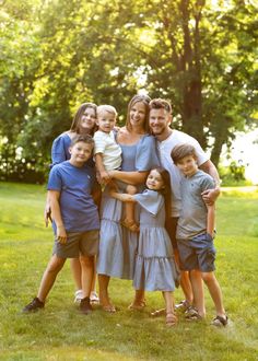 a family posing for a photo in the park