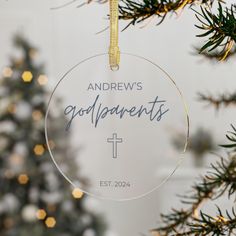 an ornament hanging from a christmas tree with the name and date on it