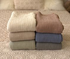 four folded towels sitting on top of a bed