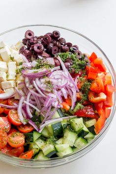 greek salad with olives, tomatoes, cucumbers, onions and feta cheese