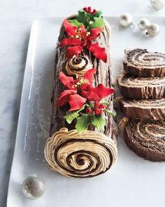 a white plate topped with slices of chocolate cake and christmas decorations on top of it