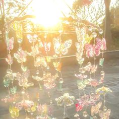 the sun is shining through some glass butterflies