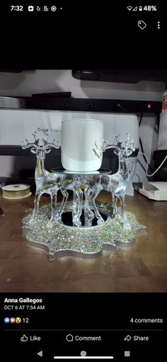 an image of a glass reindeer with a white hat on it's back legs