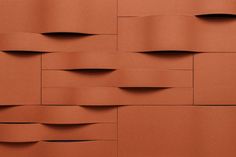 an orange brick wall with wavy lines on it