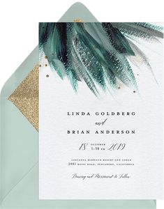 an elegant wedding card with gold glitter and green feathers on the front, is shown