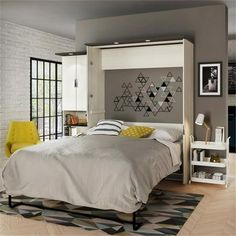 a bedroom with a white bed and gray walls