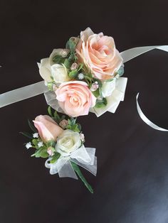 two bouquets of pink and white roses tied together