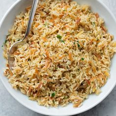 a white bowl filled with rice and carrots