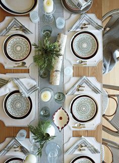 the table is set with dishes and place settings