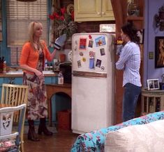 two women standing in a kitchen talking to each other