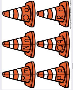 four orange cones with faces drawn on them