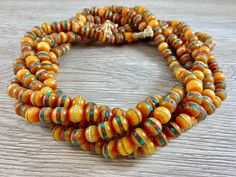 Material: Tibetan Mala Beads Color: Tan/Amber color Shape: Round with the center stripe being brass or copper & turquoise and coral color bits. Size: Around 10mm Beads per loop: Around 108 pcs Hole Size: 2mm This is NOT Finished Necklace! Beads ONLY!! You will need to make your own necklace/bracelet/designs Because these beads are handmade, each bead can vary in size and color. We appreciate you for understanding! :) Make Your Own Necklace, Tibetan Mala, Christmas Tree Beads, Turquoise And Coral, Necklace Beads, Amber Color, Appreciate You, Mala Beads, Color Shapes