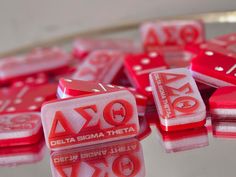 red and white dices sitting on top of a glass table next to each other