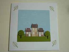 an image of a house with trees on the front and back side, framed in white paper