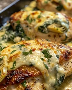 some chicken with cheese and spinach in a pan