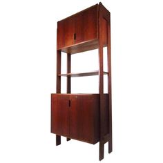 a tall wooden shelf with two doors on the front and one door open to reveal a cabinet