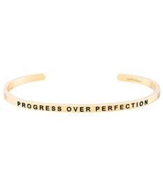 The Mantraband Progress Over Perfection Bracelet is an understated, everyday accessory with an engraved intention. It's a go-to gift, thanks to the gift-ready recyclable packaging with an inspirational message, specific to the mantra. Features "Progress Over Perfection"-engraved adjustable bracelet  Nickel and lead free Stainless steel, dipped in 18K gold Gift-ready, recyclable packaging Details Color: Yellow Gold Adjustable: Yes Materials: 18K gold dipped over stainless steel; lead free and nickel free Care: To clean, wipe items with a soft cloth. Avoid frequent contact with strong chemicals, such as detergent, bleach, perfume, etc. Store in a jewelry box or soft cloth. Always remember to remove your gold jewelry before shower or exercise. Do not wear items in hot tubs or swimming pools. Progress Over Perfection, Mantra Bands, Recyclable Packaging, Gold Gift, Everyday Accessories, Gold Dipped, Hot Tubs, Inspirational Message, Recycled Packaging