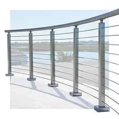 an image of a metal railing on the side of a building with water in the background