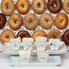 doughnuts and ice cream are displayed on trays in front of a wall