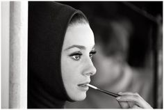 a black and white photo of a woman brushing her teeth