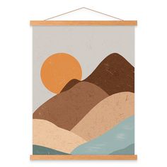 a poster hanging on a wall with mountains and the sun in the sky above it