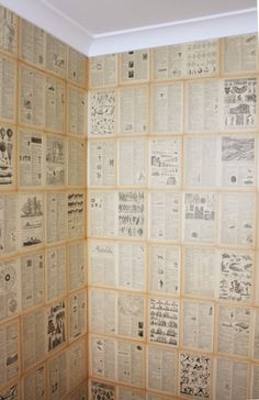 a bathroom wall covered in newspaper paper