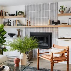 a living room filled with furniture and a fire place covered in plants on top of shelves