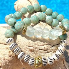 Seagrass Duo~ This striking bracelet set is made with lovely muted and matte pistachio colored Java glass beads, carved chevron beads, recycled 'sea glass' beads and gold accents. It is perfect for any occasion and can be dressed up or down. These were designed as a set ($10 savings but they can be purchased individually.  * 7 inch length unless a custom size is noted. * Comes gift-giving-ready with a Salty Sunshine branded tag, sheer drawstring bag and crinkle paper.   * Free shipping on orders $35 and above! Follow Salty Sunshine Jewelry on Instagram and/or favorite our Etsy shop to stay current on product drops, sales and giveaways! Sunshine Jewelry, Gold Stretch Bracelet, Beautiful Beaded Bracelet, Sea Glass Bracelet, Muted Green, Beachy Vibes, Casual Jewelry, Pistachio Green, Shell Bracelet