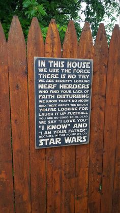 a wooden fence with a sign on it that says in this house there is no try today