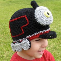 a young boy wearing a crocheted hat with an eye patch