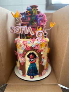 a birthday cake in the shape of a house with an image of a woman on it