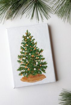 a painting of a christmas tree on a white background with pine branches and oranges