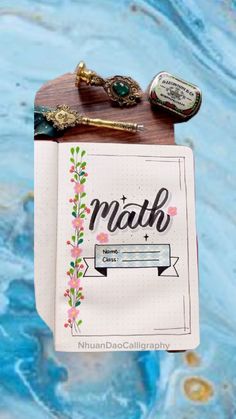 a notebook with the word math written on it next to a pen and some other items