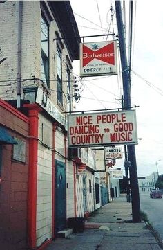 there is a sign that says nice people dancing to good country music on the street