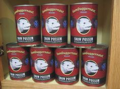 six cans of snow possum are stacked on top of each other in a cabinet