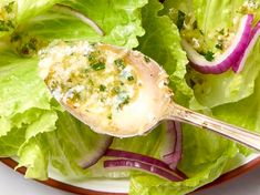 a plate filled with lettuce and topped with cheese